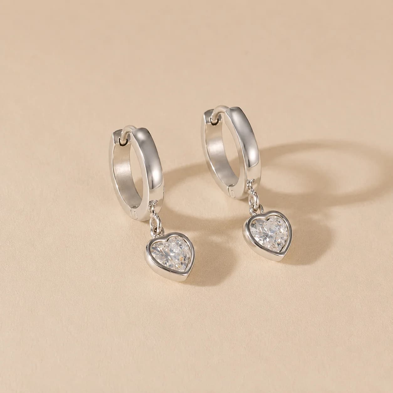 Women's Eros Heart Charm Huggie Hoops In Silver Tone